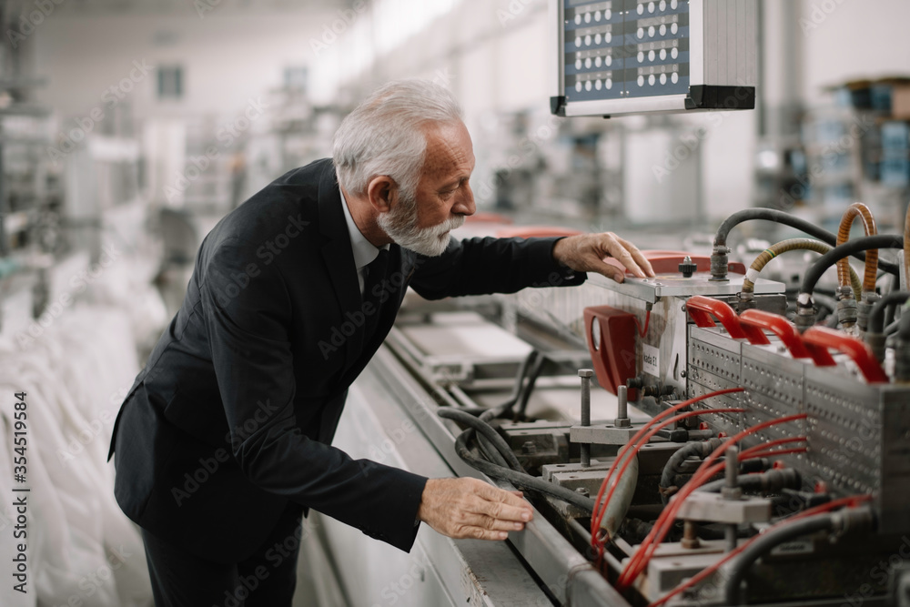 Manager checks machines at the factory. Inspector checks a factory. Manager checks machines at the factory. Inspector checks a factory.