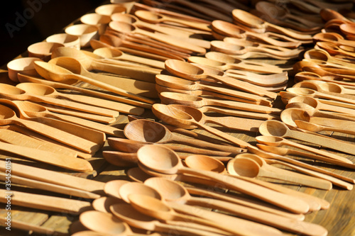 Wooden spoons in the market as a background.