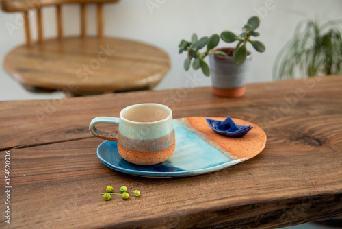 colorful handmade ceramic coffee cup on wooden table