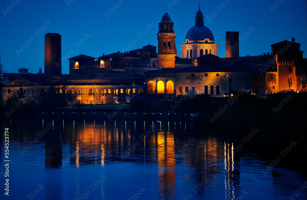 Nighttime Verona. Italy. View at old town with river. Blue hour. Picturesque cityscape.