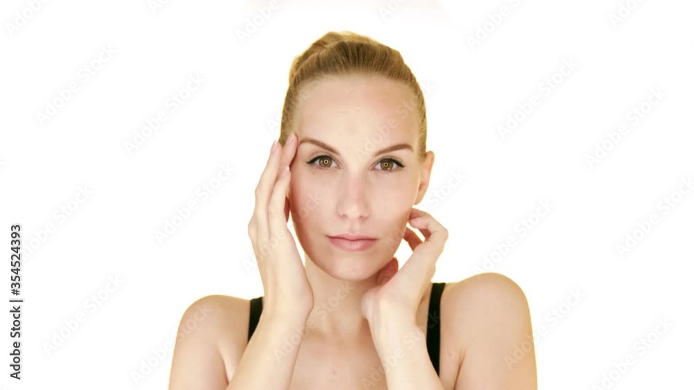 Beautiful blonde woman with clean, smoth, healthy skinn gently touches her face. Beautiful blonde woman with clean, smoth, healthy skinn gently touches her face.