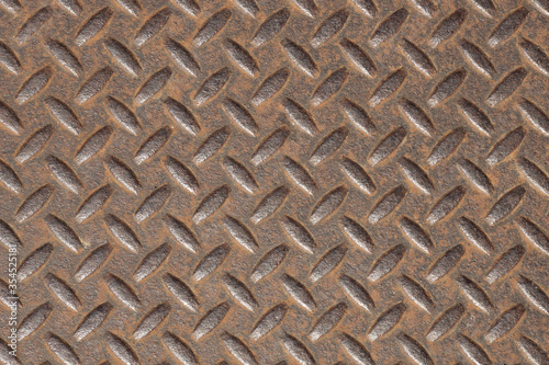 Oval pattern on the surface of the iron rusty walls, which are used as a door or gate because of its sturdy. Closeup.