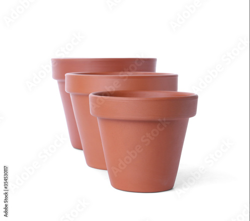 Stylish terracotta flower pots isolated on white