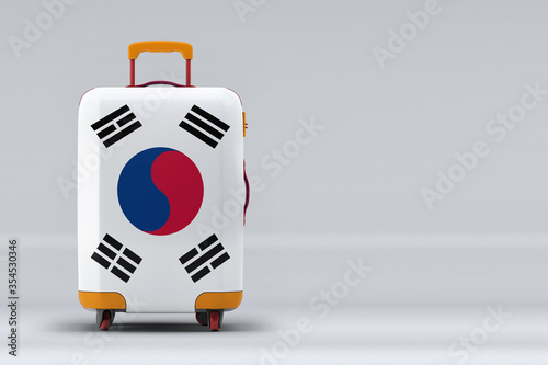 South Korea national flag on a stylish suitcases on color background. Space for text. International travel and tourism concept. 3D rendering.