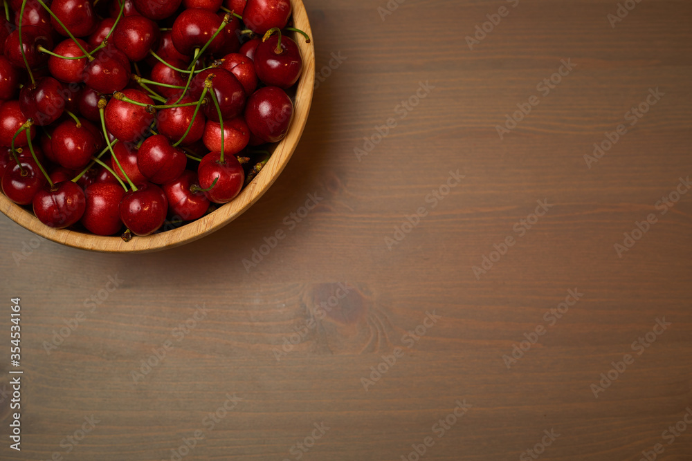 Green spring red cherries on wooden background selective focus cherry Green spring red cherries on wooden background selective focus cherry