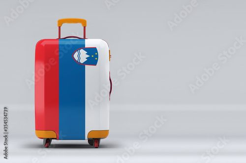Slovenia national flag on a stylish suitcases on color background. Space for text. International travel and tourism concept. 3D rendering.