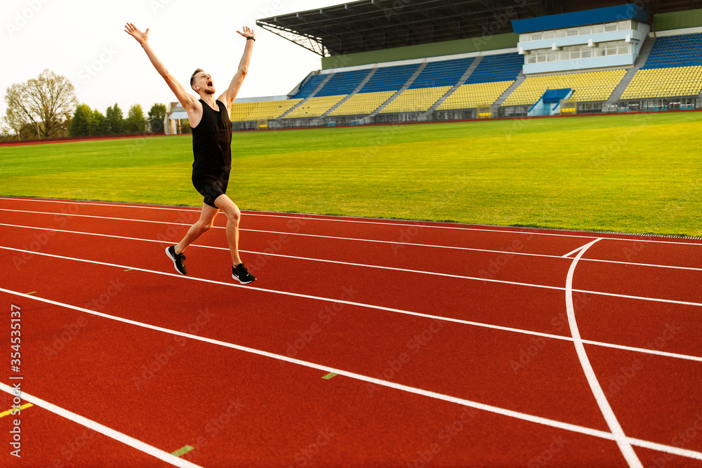 Fototapeta premium Happy athlete won the stadium race. Sport winner