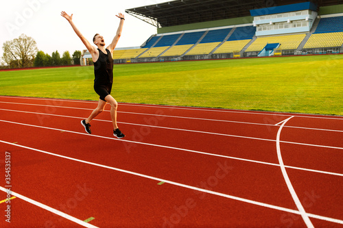 Happy athlete won the stadium race. Sport winner  photo