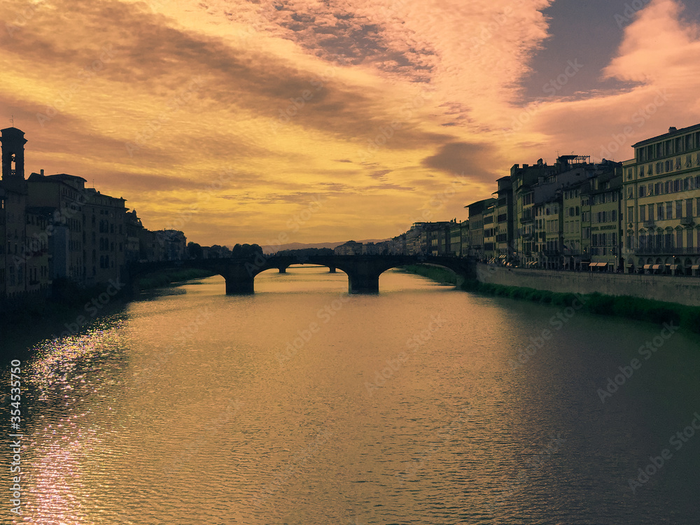 Sunset on the Arno River and perspective of its bridges