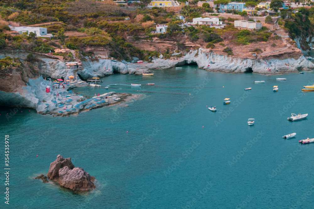 Fototapeta premium View of the harbor and port at Ponza island in the summer season. The place is typical for its blue water and colorful houses. Ponza is the largest island of the Italian Pontine Islands archipelago.