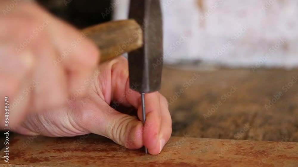 carpenter hammers nail on wood carpenter hammers nail on wood