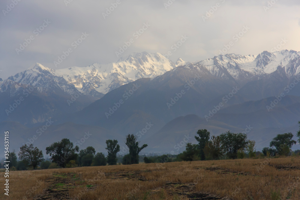 Summer mountain landscape. Mountain peaks and clouds. Zaili Alatau. Kazakhstan