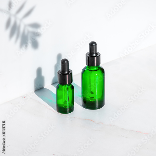 Natural cosmetics serum, extracts and oils for skin and hair care in a bottle with a pipette. The concept of organic herbal cosmetics for beauty.