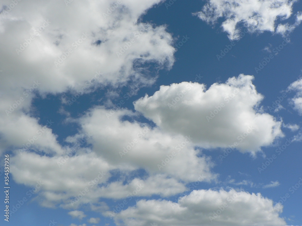 Beautiful blue sky with clouds background. Sky clouds. Air and fluffy clouds in the blue sky on a sunny day, background texture. Copy space. The concept of hope. Beautiful blue sky with clouds background. Sky clouds. Air and fluffy clouds in the blue sky on a sunny day, background texture. Copy space. The concept of hope.