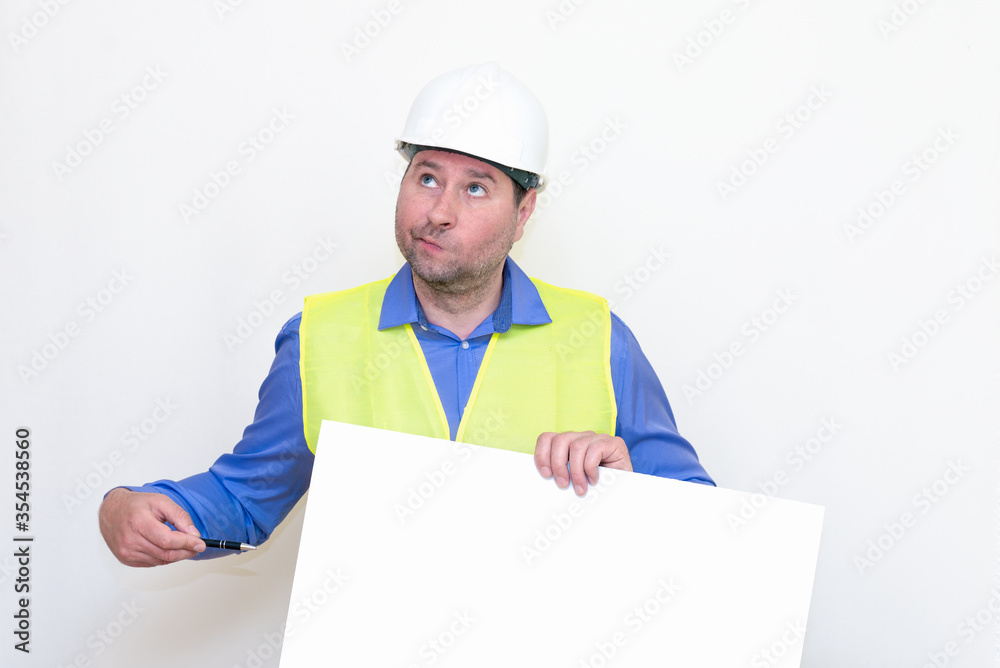 Surprised Engineer man wearing a helmet and reflector vest, standing and holding a billboard. White background. Surprised Engineer man wearing a helmet and reflector vest, standing and holding a billboard. White background.