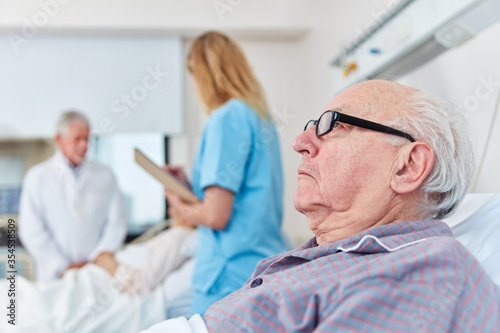 Sick senior man is lying in the hospital bed