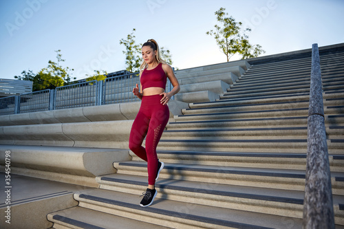 Принти на полотні Outdoor jogging in the early morning in the city on a river, intensive running t