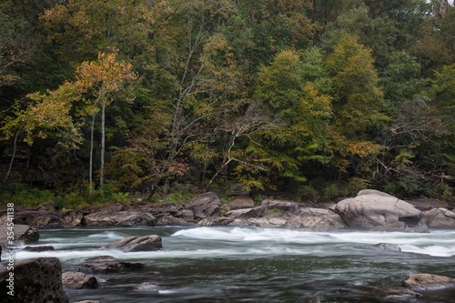 Tygart Valley River with long exposure surrounded by trees at daylight in West Virginia photo