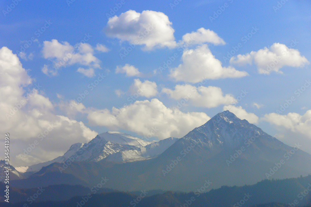 Summer mountain landscape. Mountain peaks and clouds. Zaili Alatau. Kazakhstan
