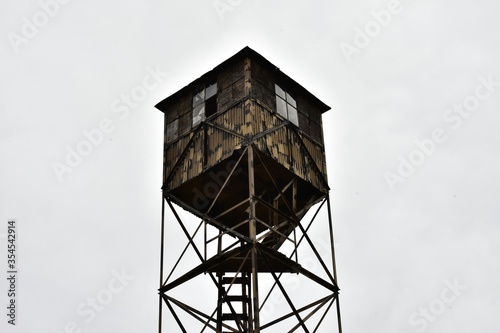 Old wooden watchtower against the cloudy sky photo