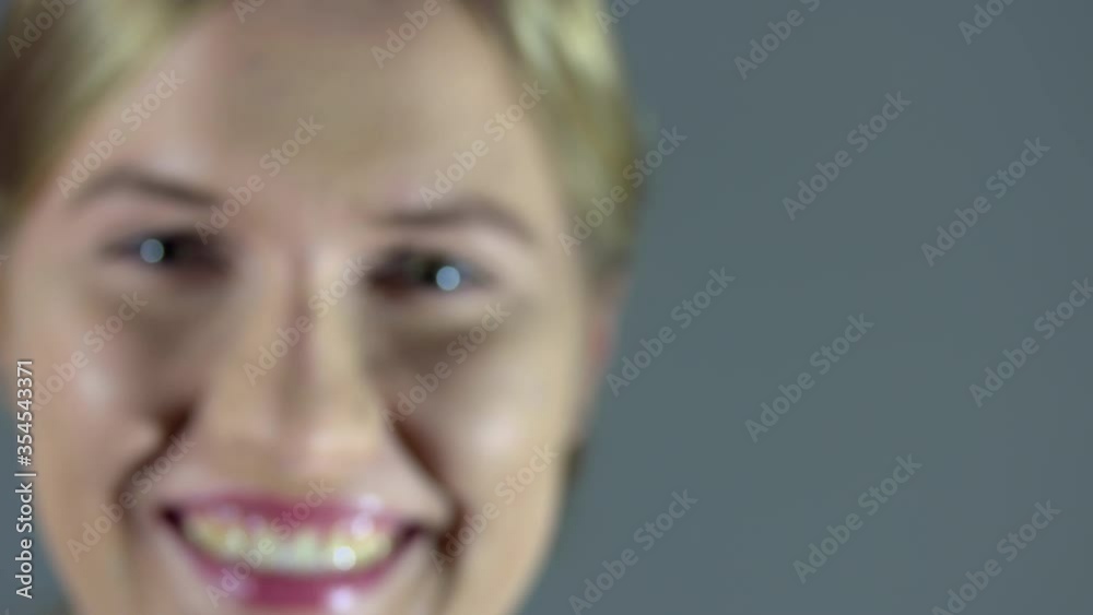 Closeup on the face of a smiling blond woman. From out of focuse to focuse. Closeup on the face of a smiling blond woman. From out of focuse to focuse.