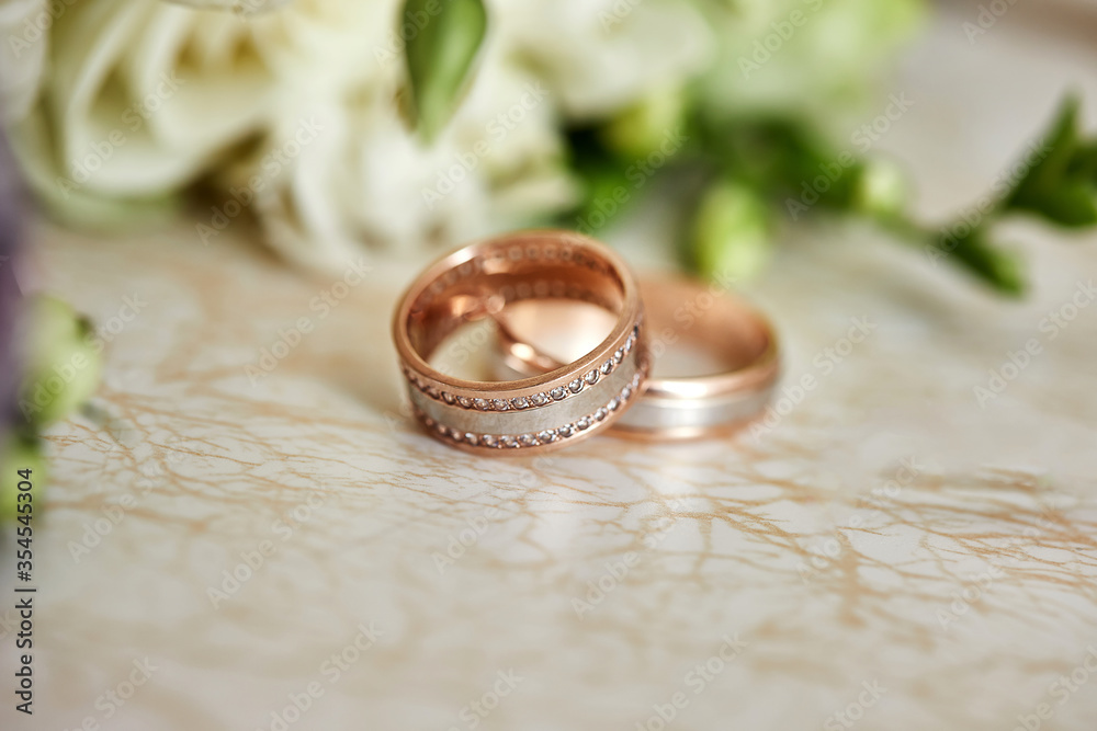 wedding rings lie near bridal bouquet wedding rings lie near bridal bouquet