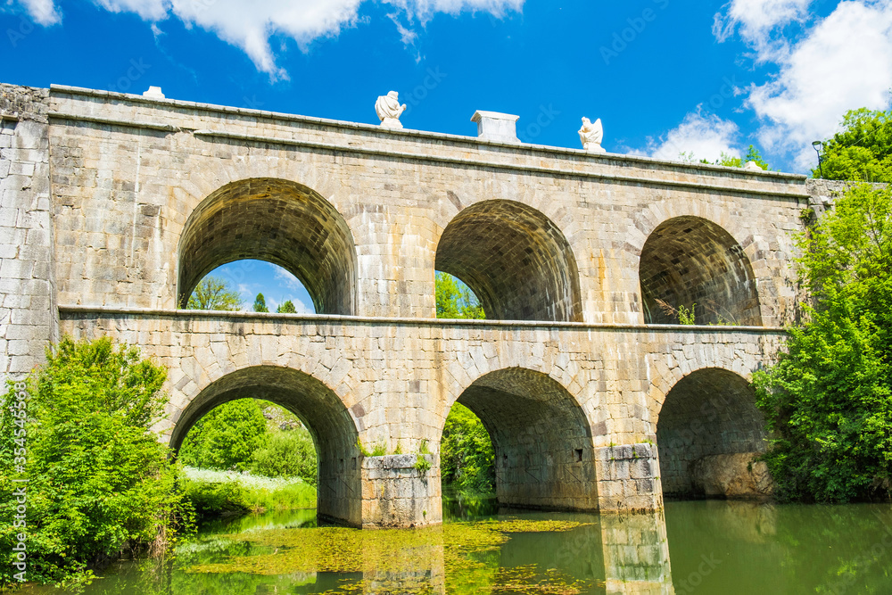 Croatia, beautiful 19 century stone bridge with arches in Tounj on Tounjcica river Croatia, beautiful 19 century stone bridge with arches in Tounj on Tounjcica river