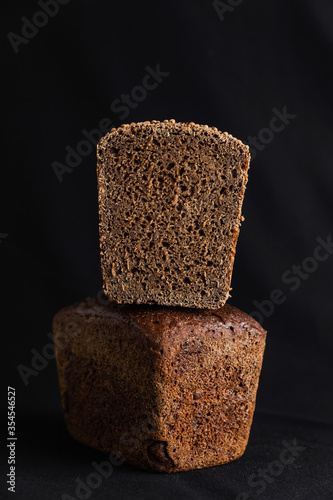 Russian black bread on black background