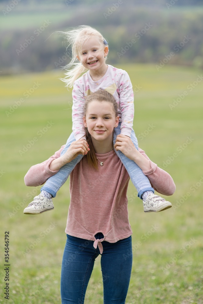 Fototapeta premium Two little sisters girls on spring portrait.