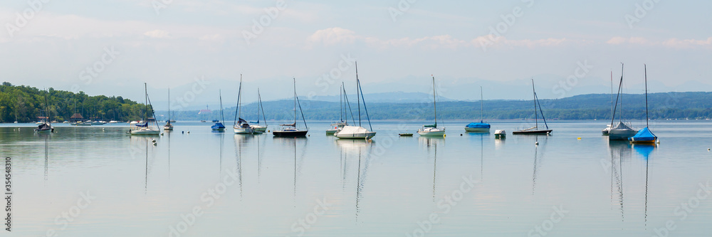 Panorama with anchoring sailboats and small yachts at Ammersee (Lake Ammer)