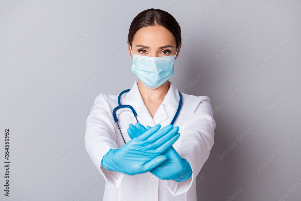 Photo of serious virologist doc lady experienced professional hold crossed palms infected zone wear gloves facial mask medical uniform lab coat stethoscope isolated grey background Photo of serious virologist doc lady experienced professional hold crossed palms infected zone wear gloves facial mask medical uniform lab coat stethoscope isolated grey background