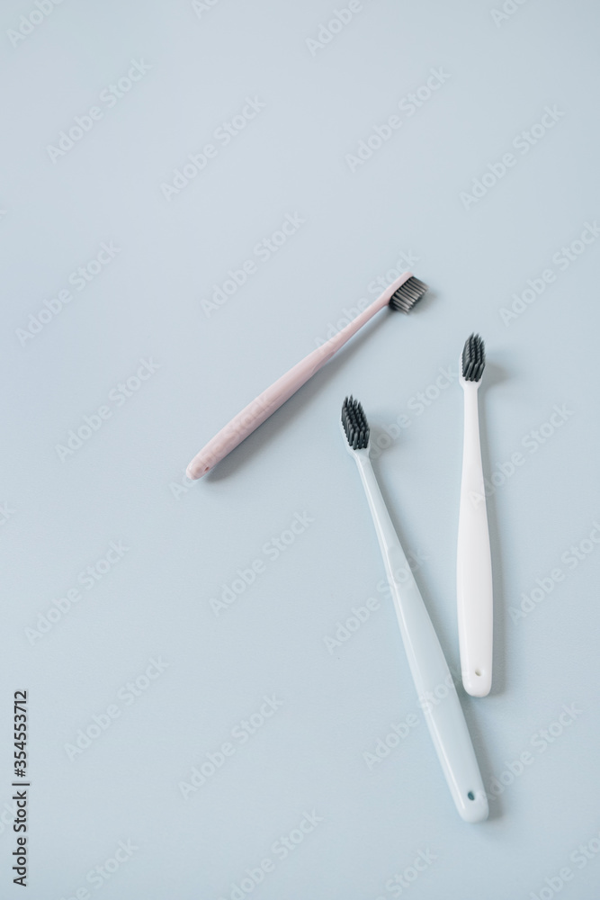 Toothbrushes on blue background. Flat lay, top view oral care, dental hygiene concept. Toothbrushes on blue background. Flat lay, top view oral care, dental hygiene concept.