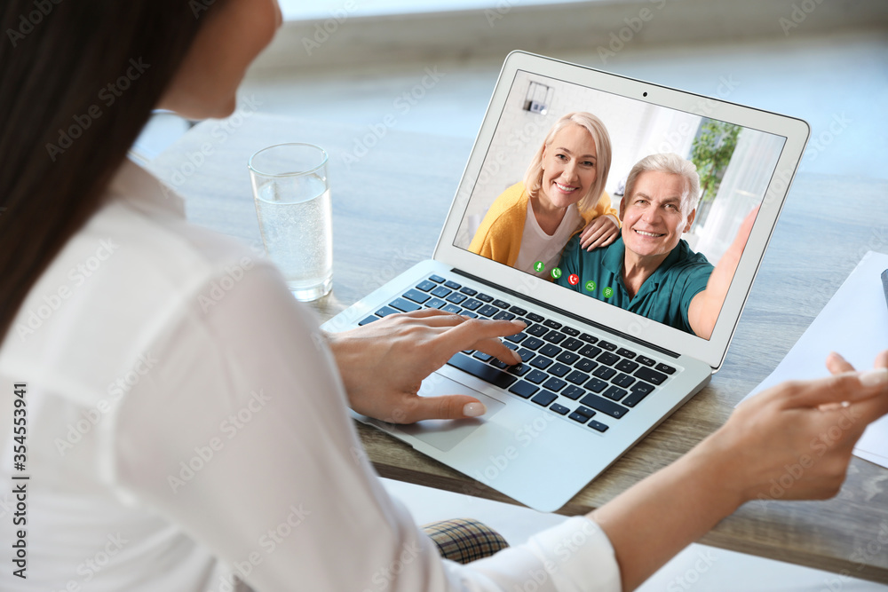 Young woman having video chat with her grandparents at home, focus on screen Young woman having video chat with her grandparents at home, focus on screen
