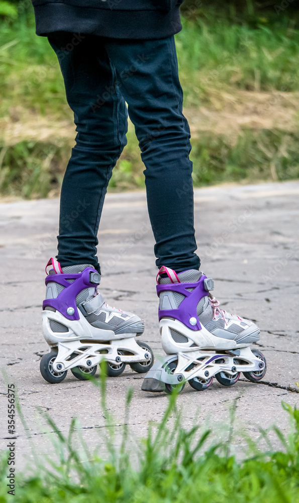 Girl on rollerblades or Inline skates having a nice time in the park