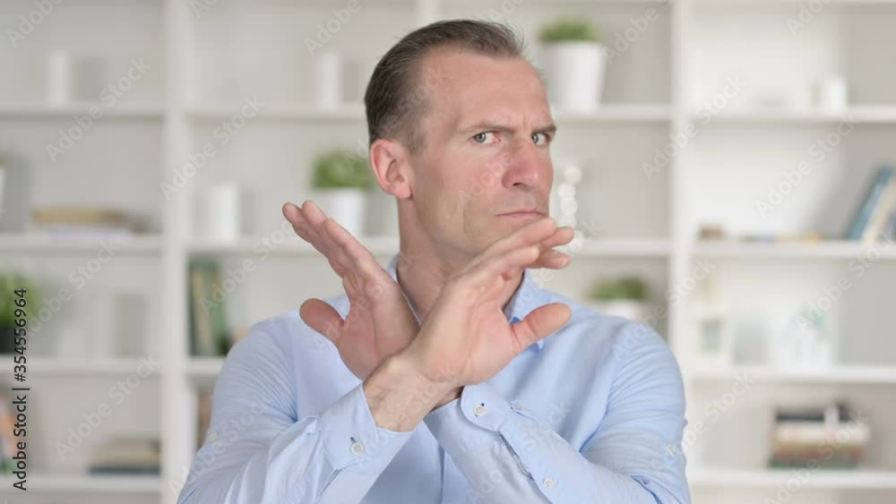 Portrait of Middle Aged Businessman saying No with Hand Gesture Portrait of Middle Aged Businessman saying No with Hand Gesture