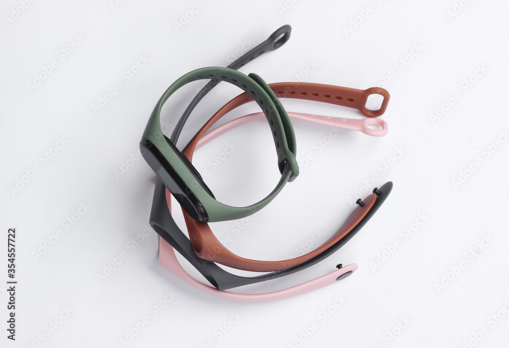 Fototapeta premium Smart bracelet with interchangeable straps on white background. Modern gadgets