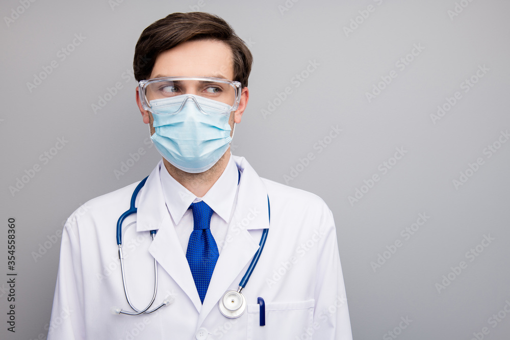 Closeup photo of attractive serious virologist doc guy professional surgeon listen patient wear facial protective mask medical uniform lab coat stethoscope isolated grey background Closeup photo of attractive serious virologist doc guy professional surgeon listen patient wear facial protective mask medical uniform lab coat stethoscope isolated grey background