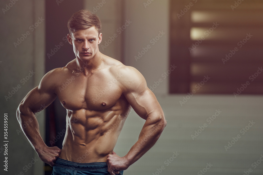 Bodybuilder strong man pumping up abs muscles Bodybuilder strong man pumping up abs muscles