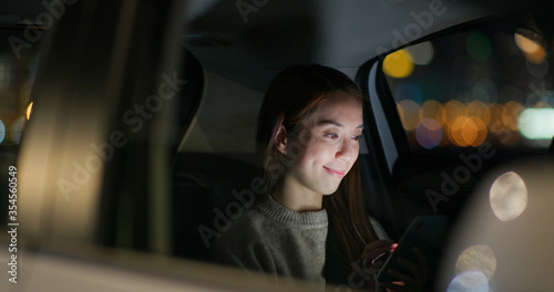 Woman use of smart phone on car © leungchopan