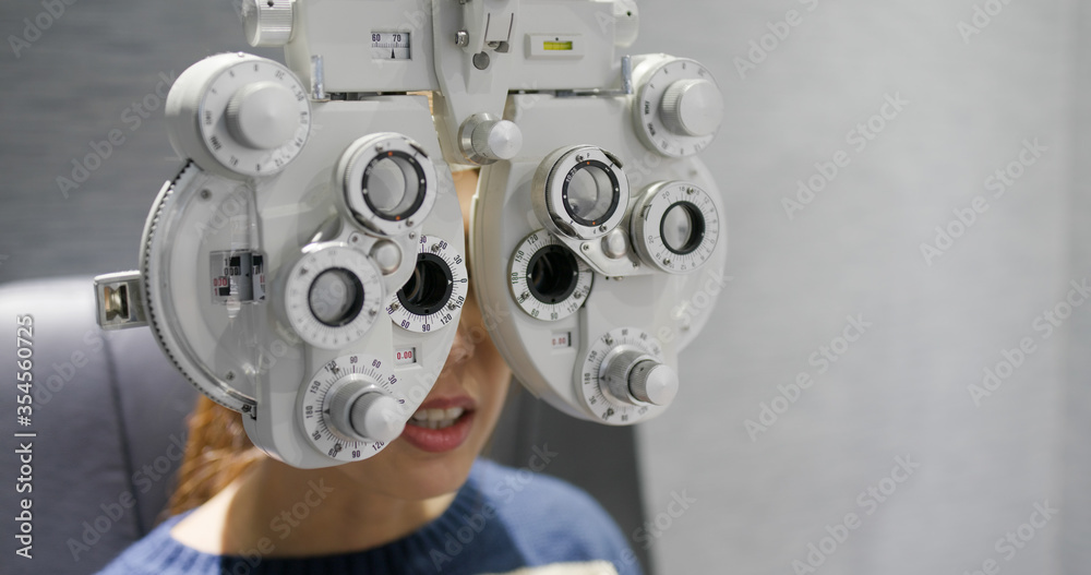 Fototapeta premium Woman check her eye at clinic