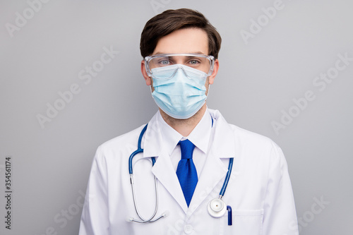 Photo of attractive handsome serious doc guy professional surgeon specialist good mood listen patient wear facial protective mask medical uniform lab coat stethoscope isolated grey background