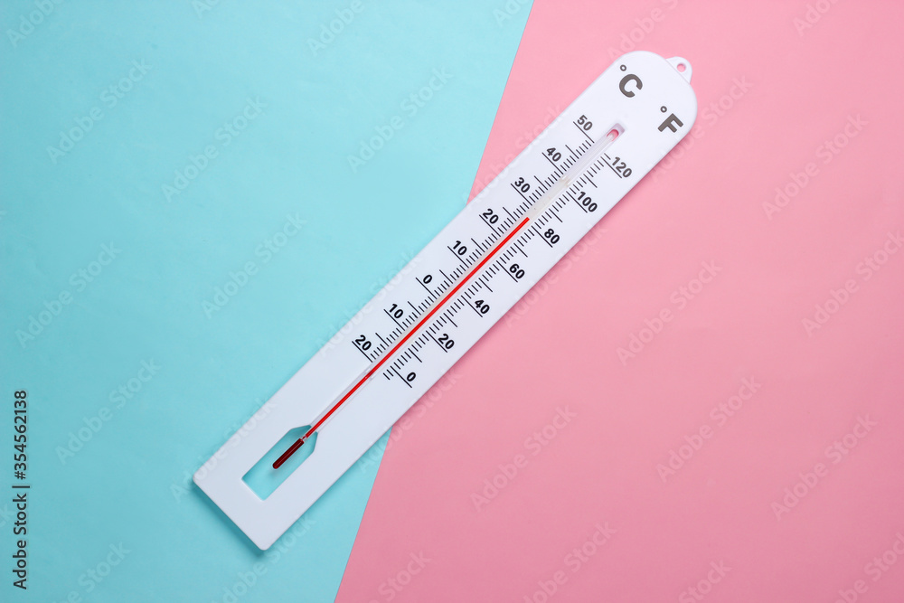 Weather thermometer on a blue-pink pastel background. Climate control. Top view Weather thermometer on a blue-pink pastel background. Climate control. Top view