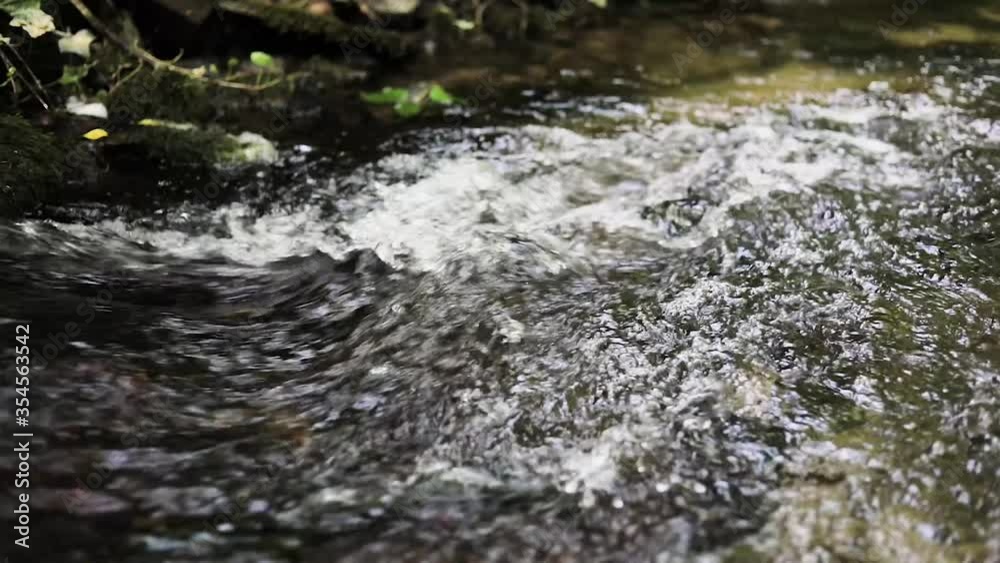 close up, slow motion A relaxing shot of a stream running over a stone close up, slow motion A relaxing shot of a stream running over a stone