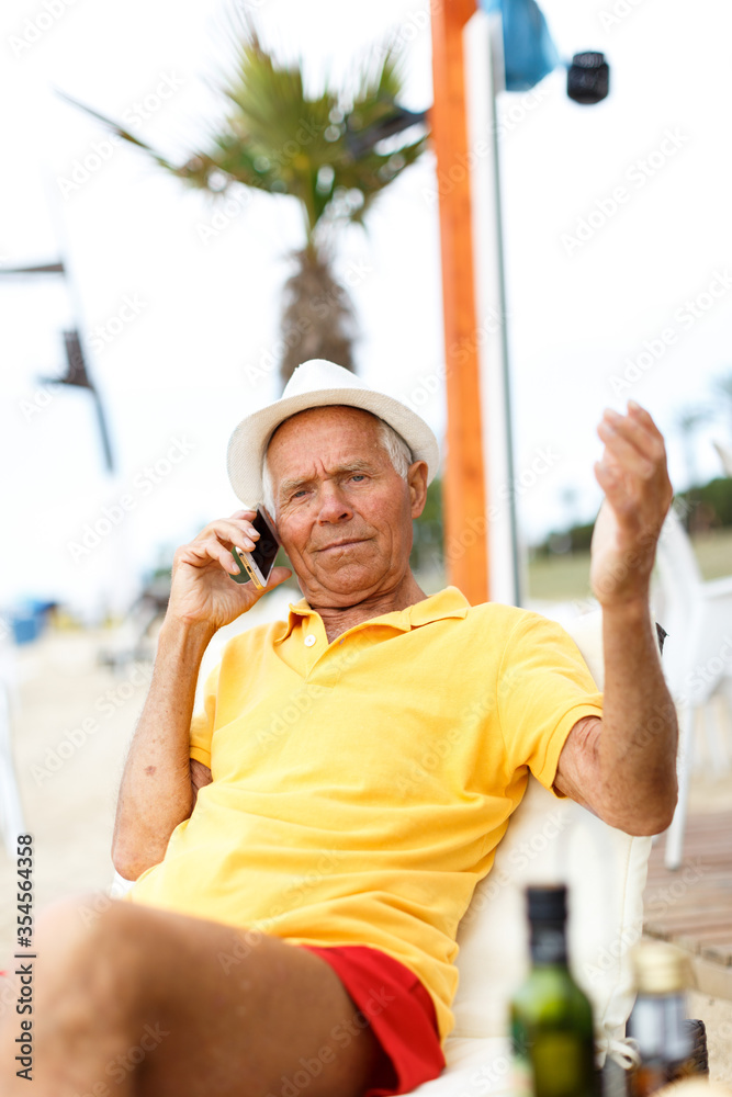 Fototapeta premium Satisfied glad man resting and speaking phone