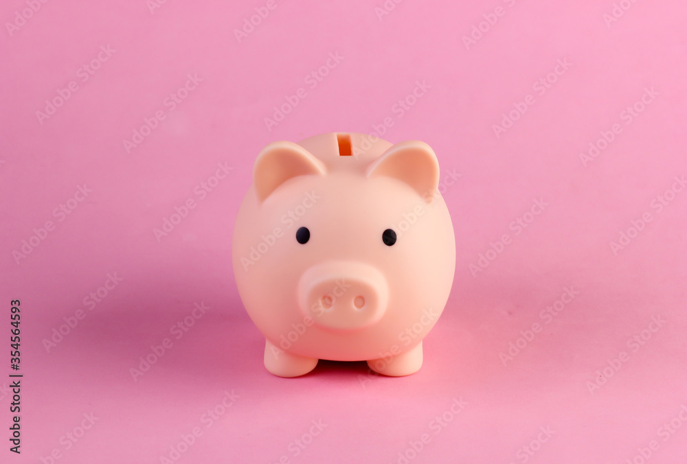 Piiggy bank close-up on a pink pastel background. Minimalism