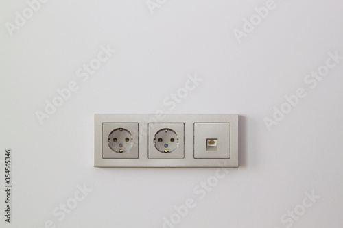 electric sockets and Internet socket in champagne color on the wall