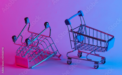 Фотография Two shopping trolley in trendy neon light