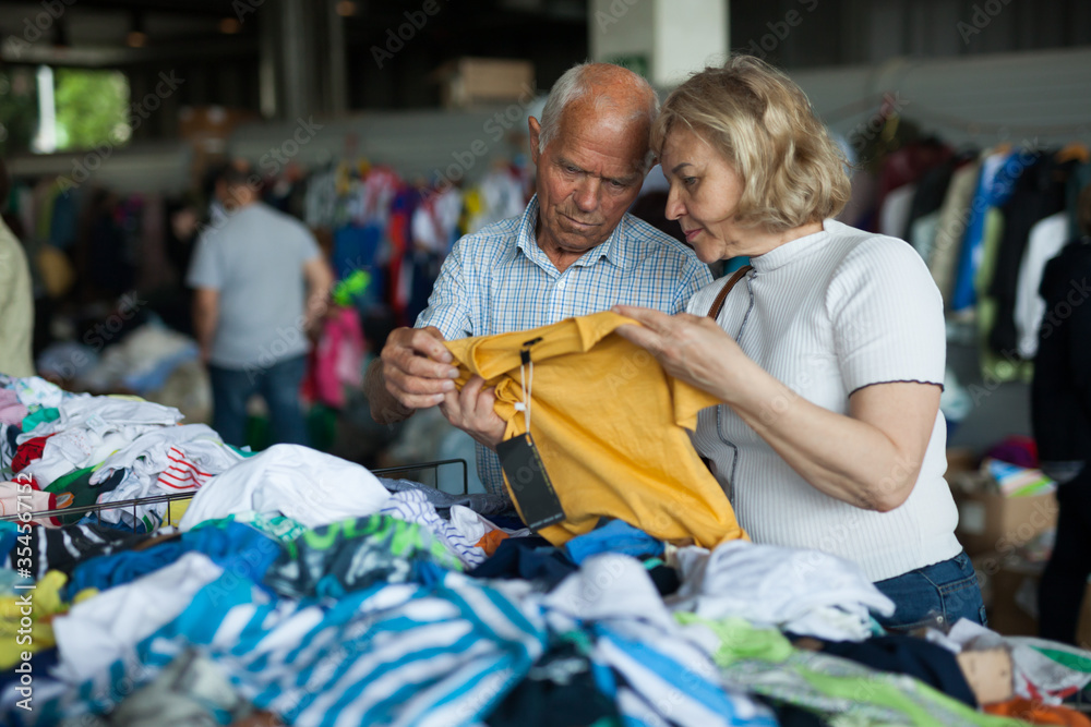 Elderly parents buy clothes for grandchildren on street market
