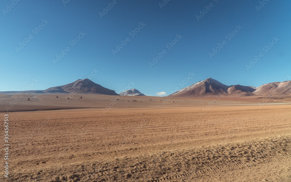 Landscape mountain Water Lake. Dry, Barren desert, snowcapped mountains wilderness. Mountain range view. Salt Flats, Uyuni, Bolivia. Copy space, Rocks, blue sky, nature, hiker, hiking