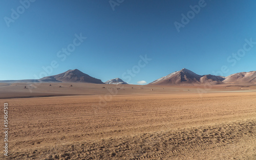 Landscape mountain Water Lake. Dry, Barren desert, snowcapped mountains wilderness. Mountain range view. Salt Flats, Uyuni, Bolivia. Copy space, Rocks, blue sky, nature, hiker, hiking